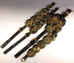 Four leather martingales, 19th century and later, each with horse brasses to include a Prince of