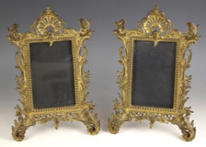 A pair of Victorian gilt-metal Rococo revival photograph frames, each with easel back supports, each