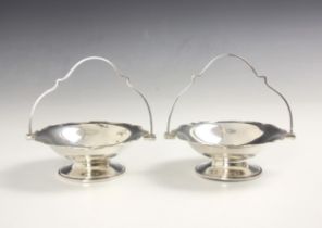 A pair of Edwardian silver bonbon dishes, R H Halford & Sons, London 1908, the shaped swing handle