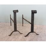 A pair of wrought iron blacksmith made fire dogs of country house proportions, early 20th century,