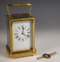A brass cased two train carriage clock, late 19th century, the profusely engraved case and