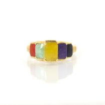 A yellow metal multi coloured hardstone dress ring, the five stepped rectangular hardstones