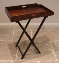 A 19th century mahogany butlers tray and stand, the galleried tray upon an associated folding 'X'