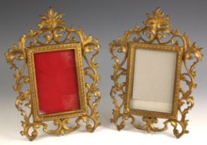 A pair of Victorian gilt-metal Rococo revival photograph frames, each with easel back supports, 30cm
