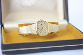 A Longines 9ct yellow gold watch, the round rectangular dial with 'chess board' style design, set to