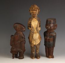 Three East African Kenya Kamba carved figures, comprising: an Askari Soldier, 29cm high, a
