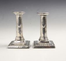 A near pair of Edwardian silver candlesticks, possibly Thomas Bradbury & Sons, London 1903-1904, the