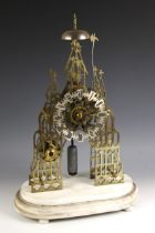 A Victorian brass eight day fusee skeleton clock, of Gothic architectural form, with overhead saucer