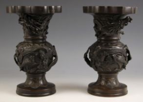 A pair of Japanese bronze vases, Meiji Period (1868-1912), each of archaic baluster form and moulded