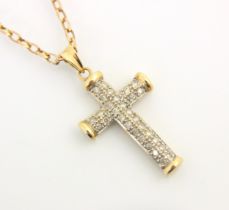 A 9ct yellow gold diamond set cross pendant, the thirty two round cut diamonds set within white claw
