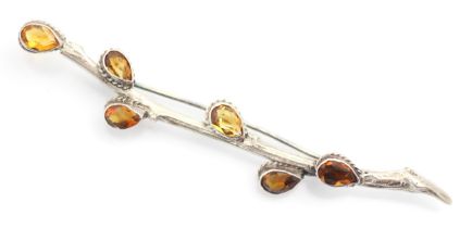A white metal and citrine brooch, the brooch designed as stylised sprig of pussy willow with six