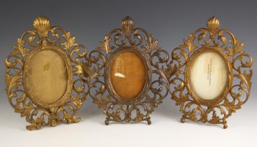 A set of three Victorian gilt-metal Florentine type photograph frames, each of oval form and cast