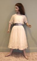A young ladies ivory tambour net dress, with blue velvet sash, mounted over ivory silk, together