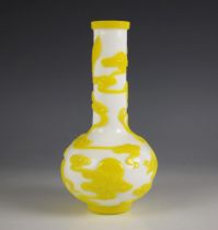 A Chinese Peking glass bottle vase, 20th century, the white opaline body decorated with yellow