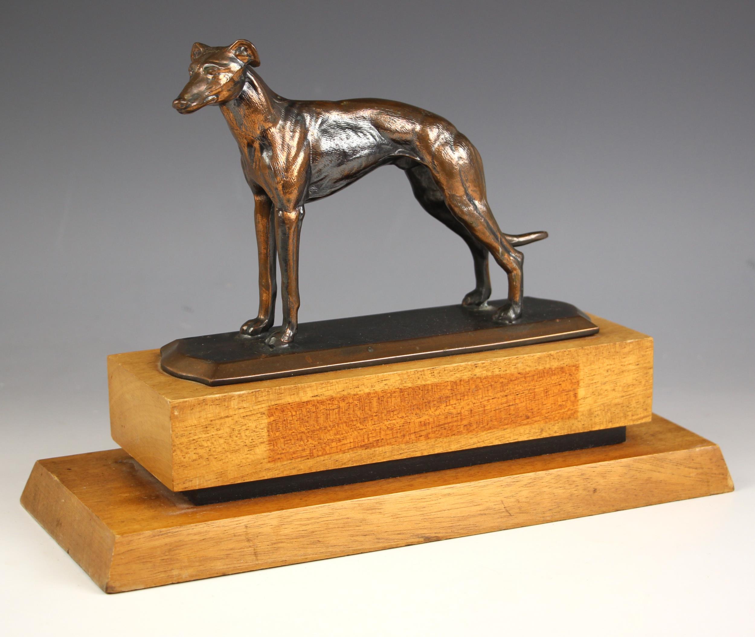 A bronze patinated spelter greyhound, modelled standing, set to a stepped wooden and ebonised - Image 2 of 2