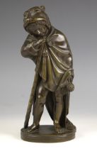 A bronze of a cloaked figure, 19th century, modelled standing wearing an animal hide hooded cloak,