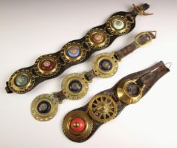 Three leather martingales, 19th century, each with horse brasses, most brasses with bullseye ceramic