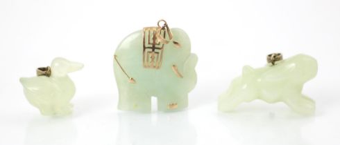 Three pieces of jade coloured carvings, including a running hare upon plain polished pendant bale