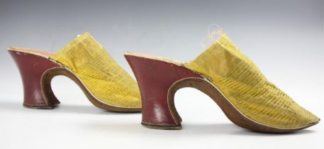 A fine and rare pair of canary yellow silk damask ladies mules, English circa 1720, the vamps with