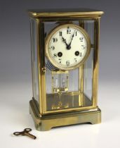 A French eight day four glass mantel clock, early 20th century, the 8cm enamelled dial applied