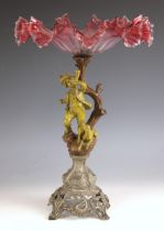 A Victorian gilt-spelter figural cranberry and clear glass comport, the cast base with a column