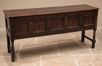 A late 17th century and later oak dresser base, the twin plank top over an arrangement of three