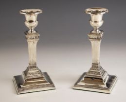 A pair of Edwardian silver candlesticks, possibly Mappin and Webb, Sheffield 1901, the beaded rims