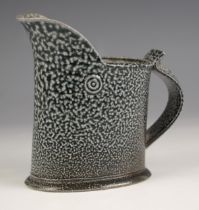 Walter Keeler (British, b.1942), a studio pottery salt glazed jug, the body decorated in a dark blue