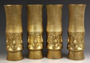 Four gilt metal vases, each of trumpet form, the body with a central band of continuous faces