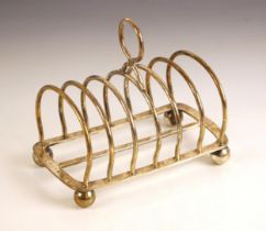 A Victorian silver toast rack, Elkington and Co Ltd, Birmingham 1898, the circular thumb piece above