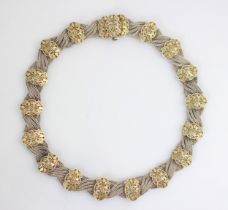 An Anatoli silver necklace, the quadruple plaited necklace with eighteen shaped panels with