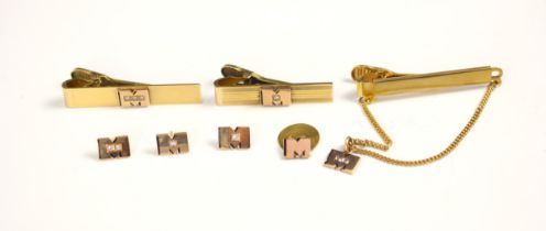 A selection of yellow metal and gold coloured jewellery, including three diamond set 'M' dress