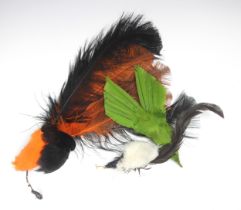 An early 20th century hat trimming of orange and black ostrich feathers, approximately 45cm long,