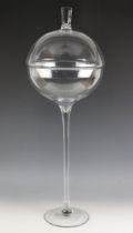 A freestanding glass bowl and cover of large proportions, the bowl leading to a tapered stem and