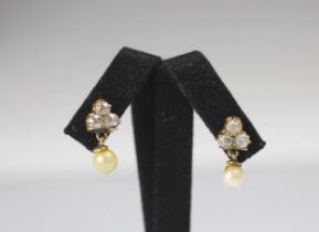 A pair of diamond and cultured pearl earrings, the three old cut diamonds in a trefoil design