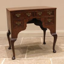 A George II style figured walnut lowboy, early 20th century, the book veneered top over an