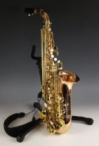 A Sakkuu Deluxe alto saxophone, in fitted case with associated stand (2)