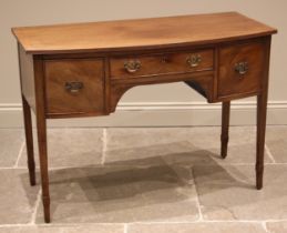 A George III mahogany dressing table, of bowfront form, the top with a reeded edge over three