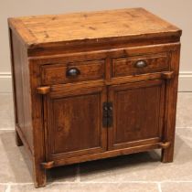 A Chinese elm side cabinet, early 20th century, the cleated plank top over two frieze drawers,