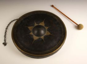 A Indian ceremonial monastery chime or dinner gong, 19th century, the hand beaten copper shield