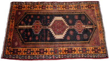 A Persian Qashqui nomadic rug, in brown, burnt orange and black colourways, the geometric and