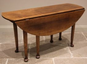 A George III style oak gateleg dining table, the oval top upon six legs of tapering cylindrical
