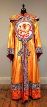 A theatrical Chinese robe of gold lorex with central dragon motif, 54cm pit to pit