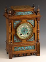 An oak cased Aesthetic Movement clock, late 19th century, the architectural case with turned pillars