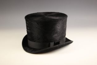 A black silk plush top hat of large proportions, possibly for a shop display, 65cm circumference,