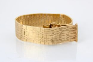 A 9ct yellow gold bracelet, the flat snake link bracelet with continuous engraved detail, with box