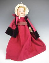 A Heubach Koppelsdorf bisque headed doll, No.342.2, with open mouth showing teeth and rolling