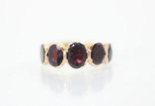 A late 19th/20th century garnet five stone ring,