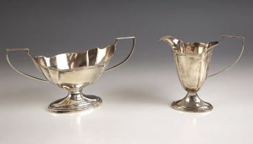 A George VI silver sugar bowl and milk jug, indistinct makers mark, Birmingham 1945, the reeded