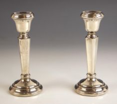 A pair of silver candlesticks, Sanders and Mackenzie, Birmingham 1968, the urn shaped sconce leading